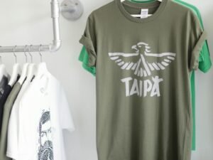 A row of fashionable T-shirts hanging stylishly in a bright retail space.